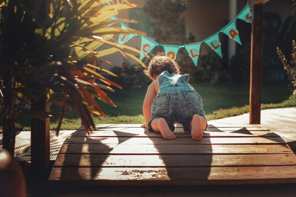 baby crawling on wooden panel